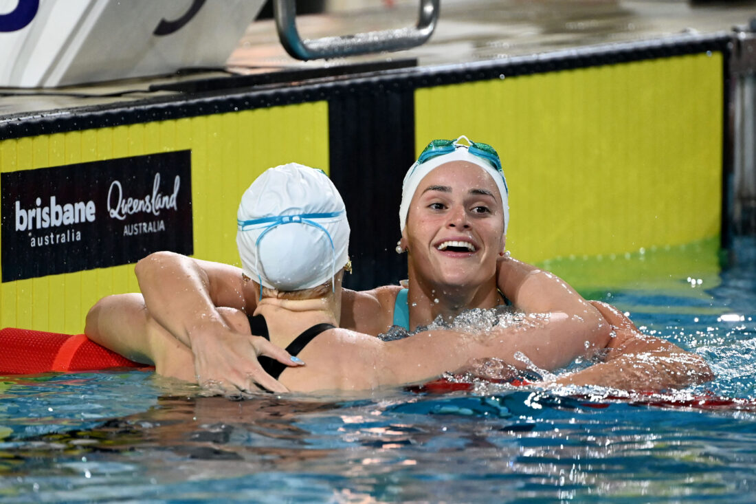 Kaylee McKeown hugs Mollie O'Callaghan after the duel that ended in the first par from one nation racing inside 58sec, ever and in one race - photo by Delly Carr, courtesy of Swimming Australia